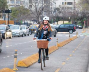 cycling politica agenda featured image showing a woman cycling in buenos aires