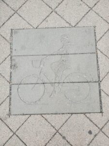 concrete imprint of a lady cycling