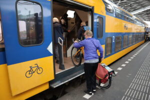 Cyclist loading a bicycle on Dutch Train